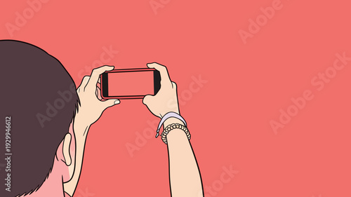A person uses a smartphone to take a picture of something with a plain red background. The focus is on the action of taking the picture.