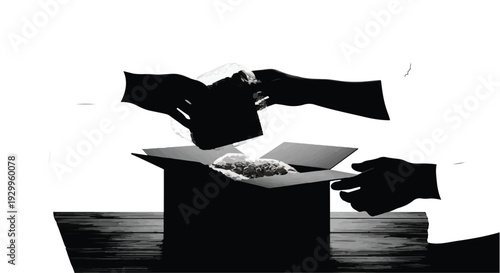 Hands reaching into a cardboard box, silhouette