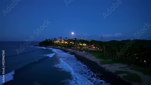 Wallpaper Mural Luxurious beachfront home, illuminated at dusk, amidst palm trees and ocean waves Torontodigital.ca