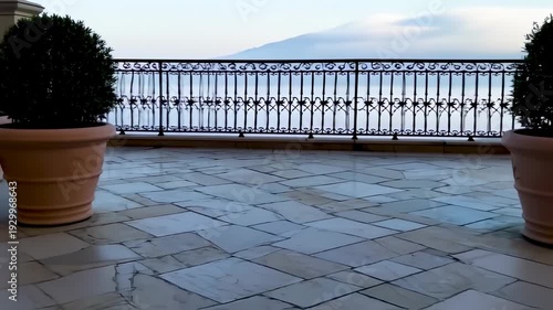 Wallpaper Mural Patio scene Large pot with topiary against a railing overlooking a hazy vista Torontodigital.ca