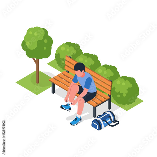 Man sitting on a park bench tying his shoelaces.