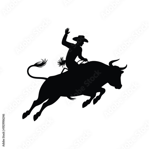 Silhouette of a cowboy riding a bucking bull in a dynamic pose
