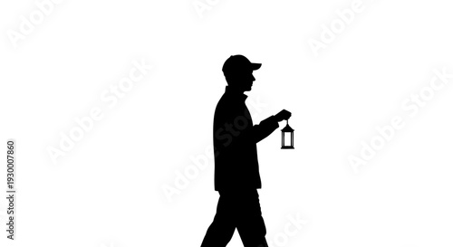 Silhouette of a man walking with a lantern in hand.