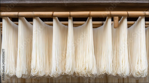 somen. Thin white Japanese somen noodles arranged neatly on a traditional bamboo drying rack, highlighting texture and orderly lines. lifestyle magazines.
