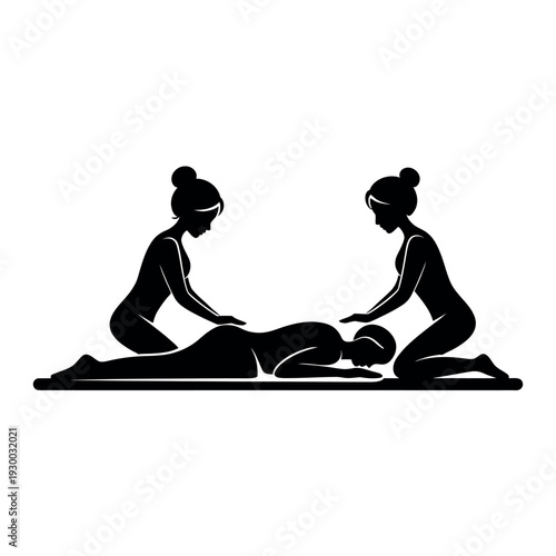 Two women providing a therapeutic massage to a person lying face down on a treatment table for relaxation.