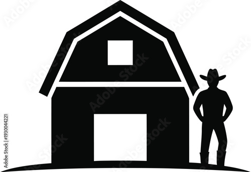 Rancher standing next to large wooden farm barn silhouette