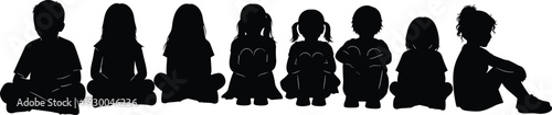Black silhouettes of a diverse group of young children sitting cross legged in a row isolated on a white background