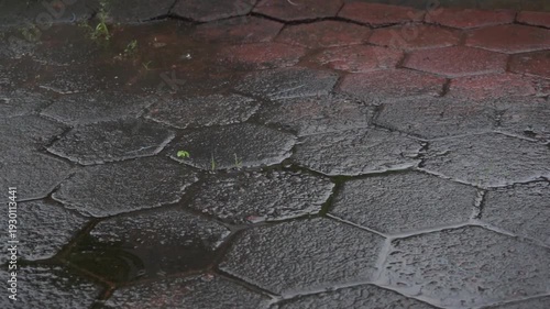 Slow motion of raindrops dripping on paving blocks