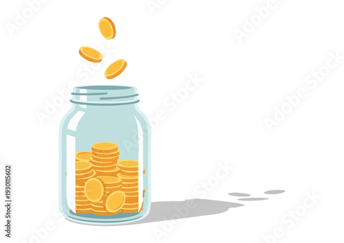 Coins being dropped into a glass jar filled with gold coins on a plain surface viewed from the side