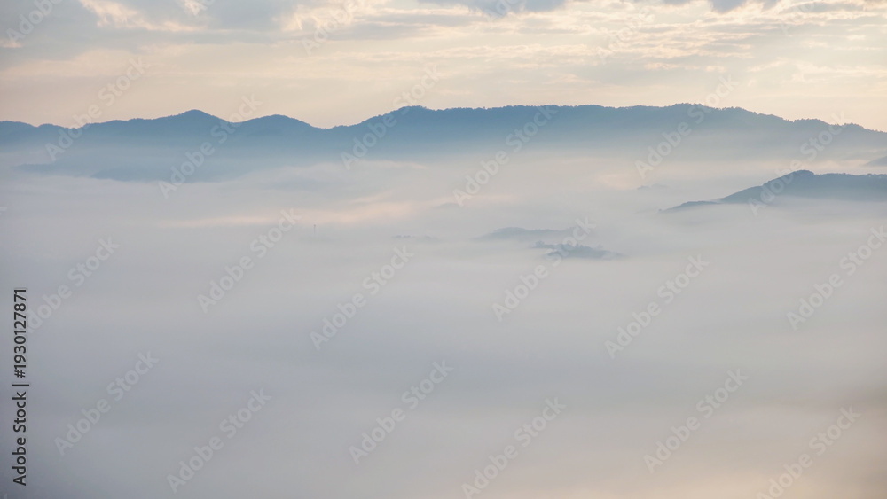 Obraz premium Aerial view of mountains and the sea of fog before sunrise by drone