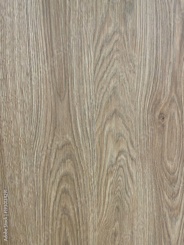 Close-up of natural light wood grain texture with subtle beige and brown tones. Detailed wooden surface showing organic lines and knots typical of oak or laminate flooring. Neutral wooden background 