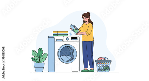 Young woman adding liquid detergent into a washing machine while doing laundry at home with a basket of clothes nearby.