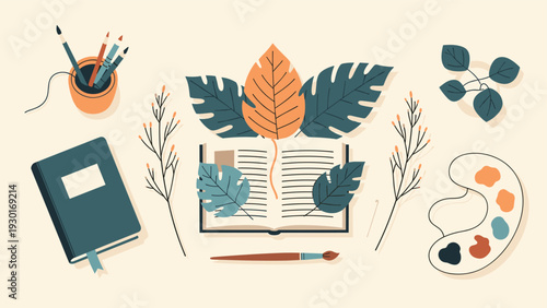 Creative workspace flat lay with an open book, leaves, notebook, paint brushes, palette, and plants on a light beige background.