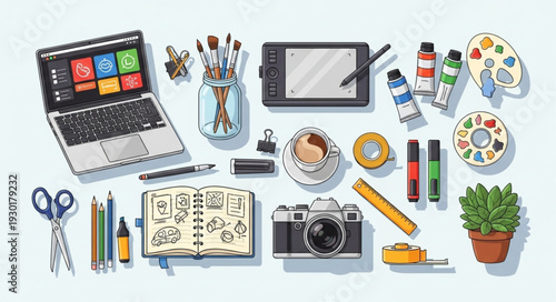 Creative workspace with laptop, camera, and art supplies, top view.