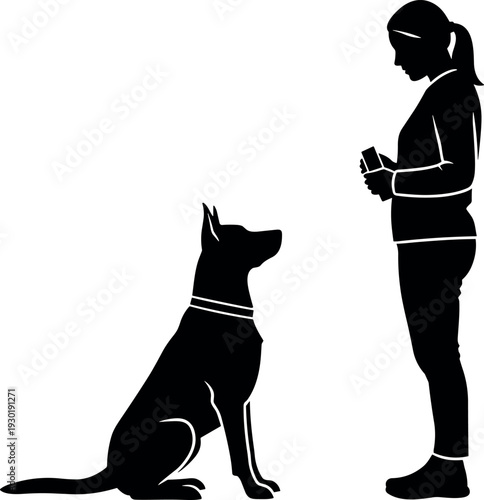 Silhouette of a woman training a German Shepherd dog using a treat reward system for obedience and animal behavior coaching.