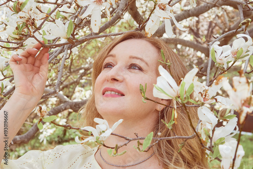 Mature woman enjoying spring blossom outdoors