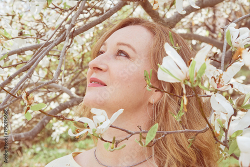 Mature woman enjoying spring blossom outdoors