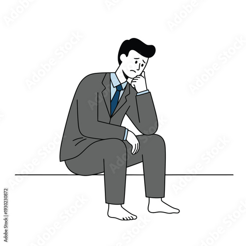 A man in a suit sitting alone, looking thoughtful and dejected, conveying feelings of sadness or contemplation.