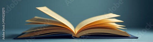 Open book sitting on a table with a blue background banner