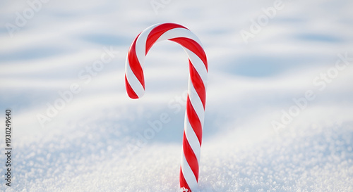 Red and white candy cane standing in snow