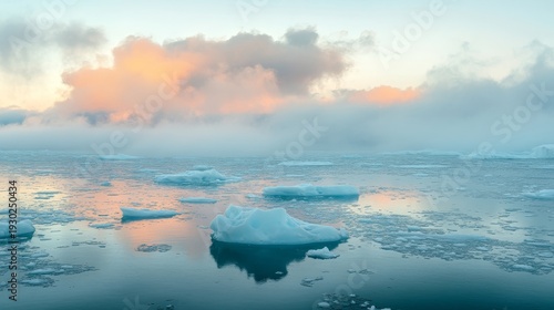 panoramic view of ice floes surrounded by melting slush, distant glaciers retreating into fog under warm colored clouds