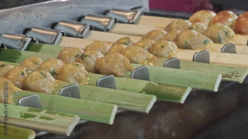 Grilled curry fish paste balls on a skewer.