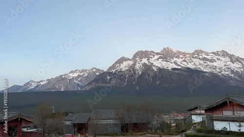 A clear view of Jade Dragon Snow Mountain shows its sharp, snow‑covered peaks rising above the valleys near Lijiang in Yunnan.