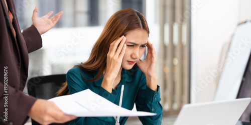Fotografie Chief and subordinate talking at workplace, dissatisfied boss points on rude mistakes on report criticizing work scolding accusing young female employee