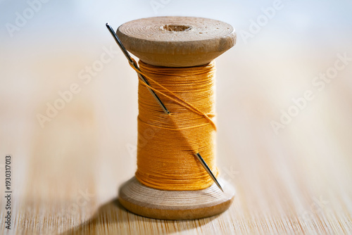 Spool of thread with a needle. Close-up.