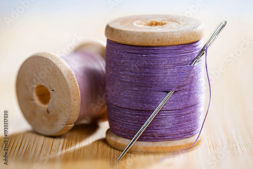 Spool of thread with a needle. Close-up.