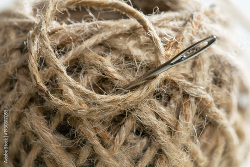 Spool of thread with a needle. Close-up.