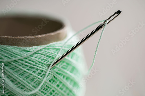 Spool of thread with a needle. Close-up.
