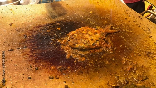 Sizzling chicken on hot grill with spatula flipping