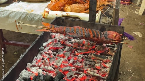 Delicious grilled fish cooking on charcoal grill outdoors