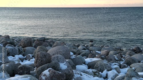 On the rocks of Dragon Eggs Beach on a March evening. Teriberka, Murmansk region, Russia