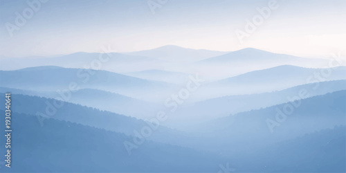A breathtaking mountain landscape blanketed in misty fog at sunrise reveals a vast forest valley under a soft blue sky as the sun peaks over the horizon