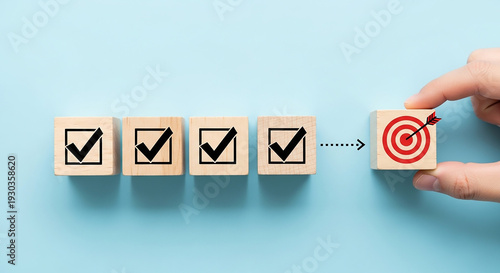 Achieving Goal: A hand places a target block, symbolizing a goal is achieved, next to completed task blocks, illustrating the power of consistent actions and progress toward a specific aim.