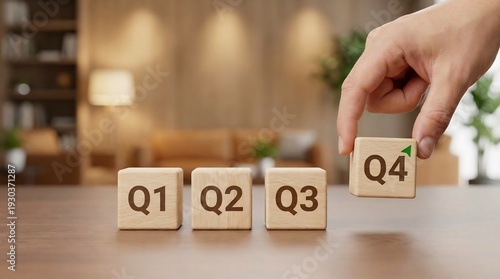 Wallpaper Mural Hand places a wooden block labeled Q4 next to Q1, Q2, and Q3 blocks, signaling the end of the business fiscal year. Torontodigital.ca