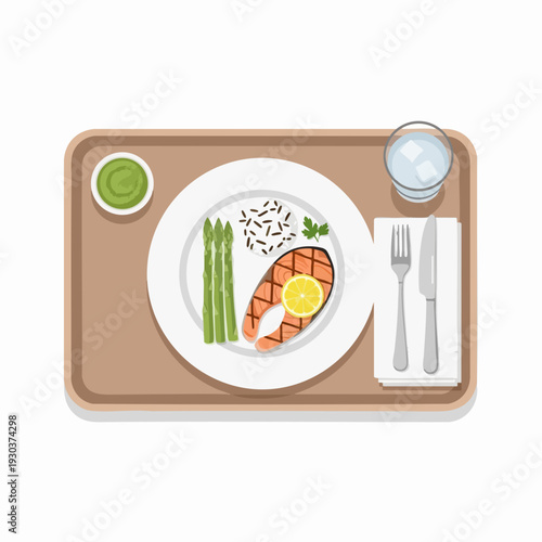 Overhead view of grilled salmon steak served with asparagus rice and green sauce on a tray alongside cutlery and a glass of water