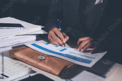 Slika na platnu Professional photo of a person's hands reviewing a contract or legal document on