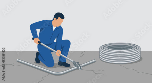Bending Conduit
An electrician using a manual conduit bender tool on the floor to put a 90-degree bend in a piece of metal pipe. Coils of unbent pipe are stacked nearby on a concrete floor. 