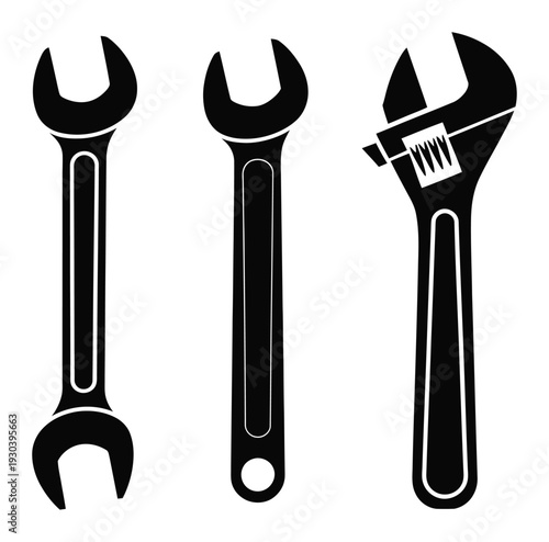 Three Black Wrenches on a White Background, Including an Adjustable Wrench