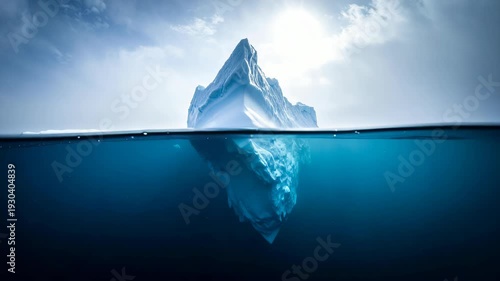 Split view of a massive iceberg floating in deep blue arctic waters under a bright sunlit sky