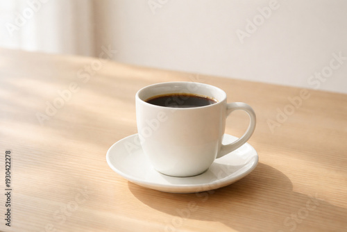 Wallpaper Mural White Ceramic Coffee Cup on Light Wooden Table with Soft Morning Sunlight, Minimal Lifestyle Background Torontodigital.ca