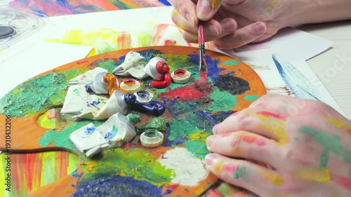 Wallpaper Mural The hands of the artist, work to create creative images in art. Art paints and brushes, applying multi-coloured strokes to the canvas using palette, gouache and watercolour. Torontodigital.ca