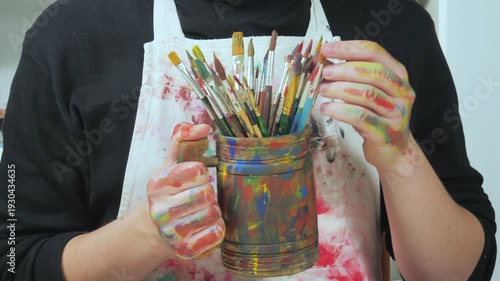 Wallpaper Mural The hands of the artist, work to create creative images in art. Art paints and brushes, applying multi-coloured strokes to the canvas using palette, gouache and watercolour. Torontodigital.ca