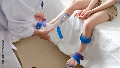 Принти на полотні Doctor carefully adjusting a custom-made orthosis on a child's leg, providing es