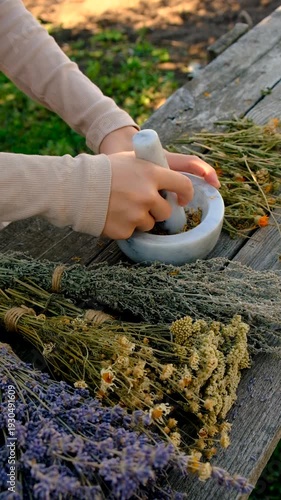 Woman with dried medicinal herbs. Selective focus.