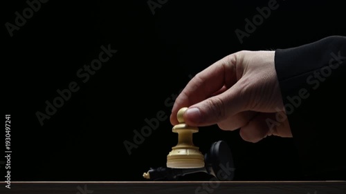 A pawn kills a king on a black background. Chess competition view of the board from below. Checkmate to the king from a pawn