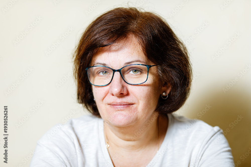 Fototapeta premium Caucasian mature female with glasses smiling in casual wear